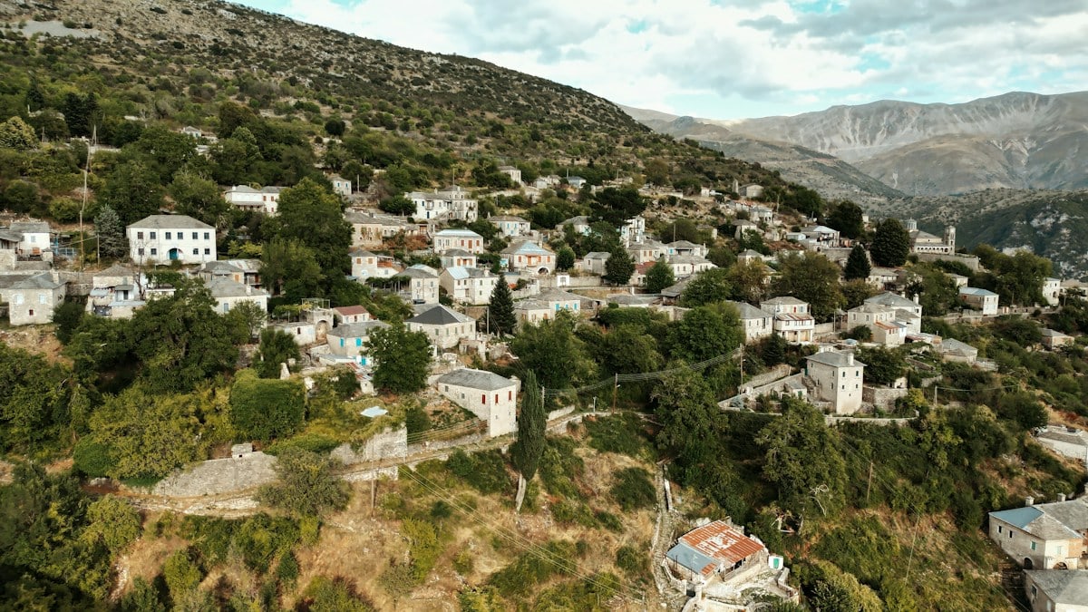 Traditional stone houses on a steep, green hillside